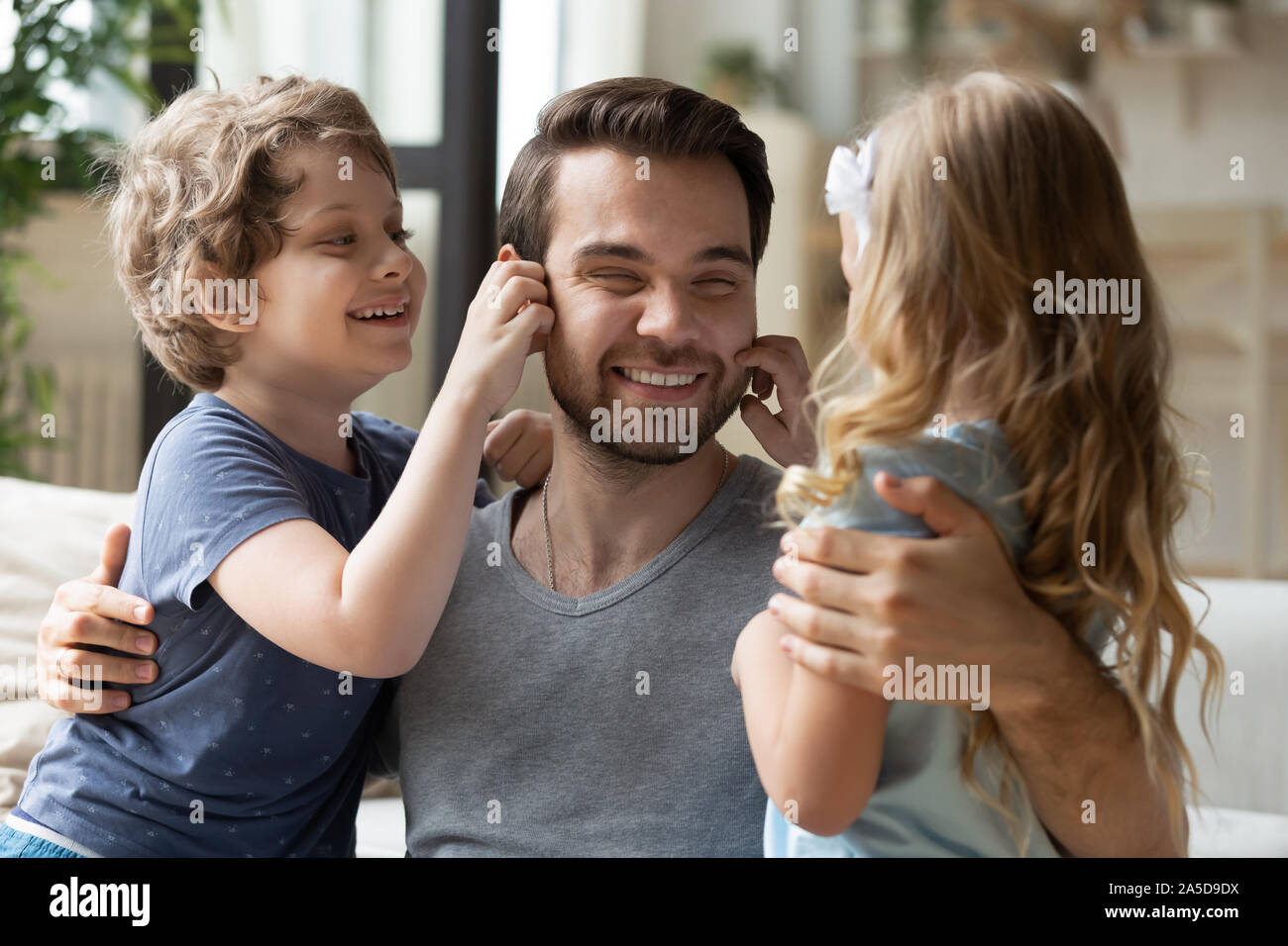 Happy father having fun with little son and daughter Stock Photo