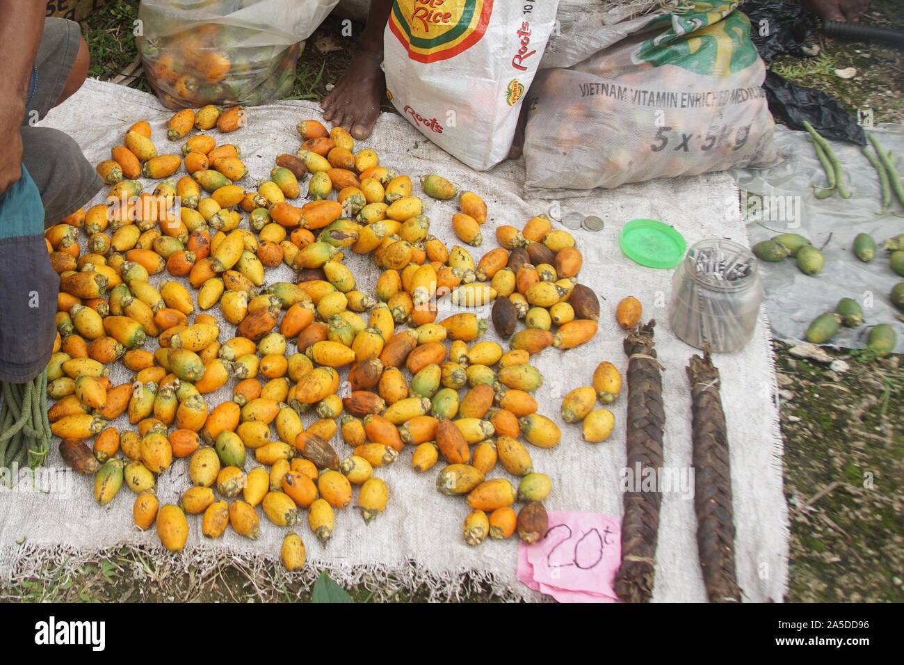 Pile of ripe orange Betel Nuts at a makeshift Market Stall in Papua New Guinea Stock Photo