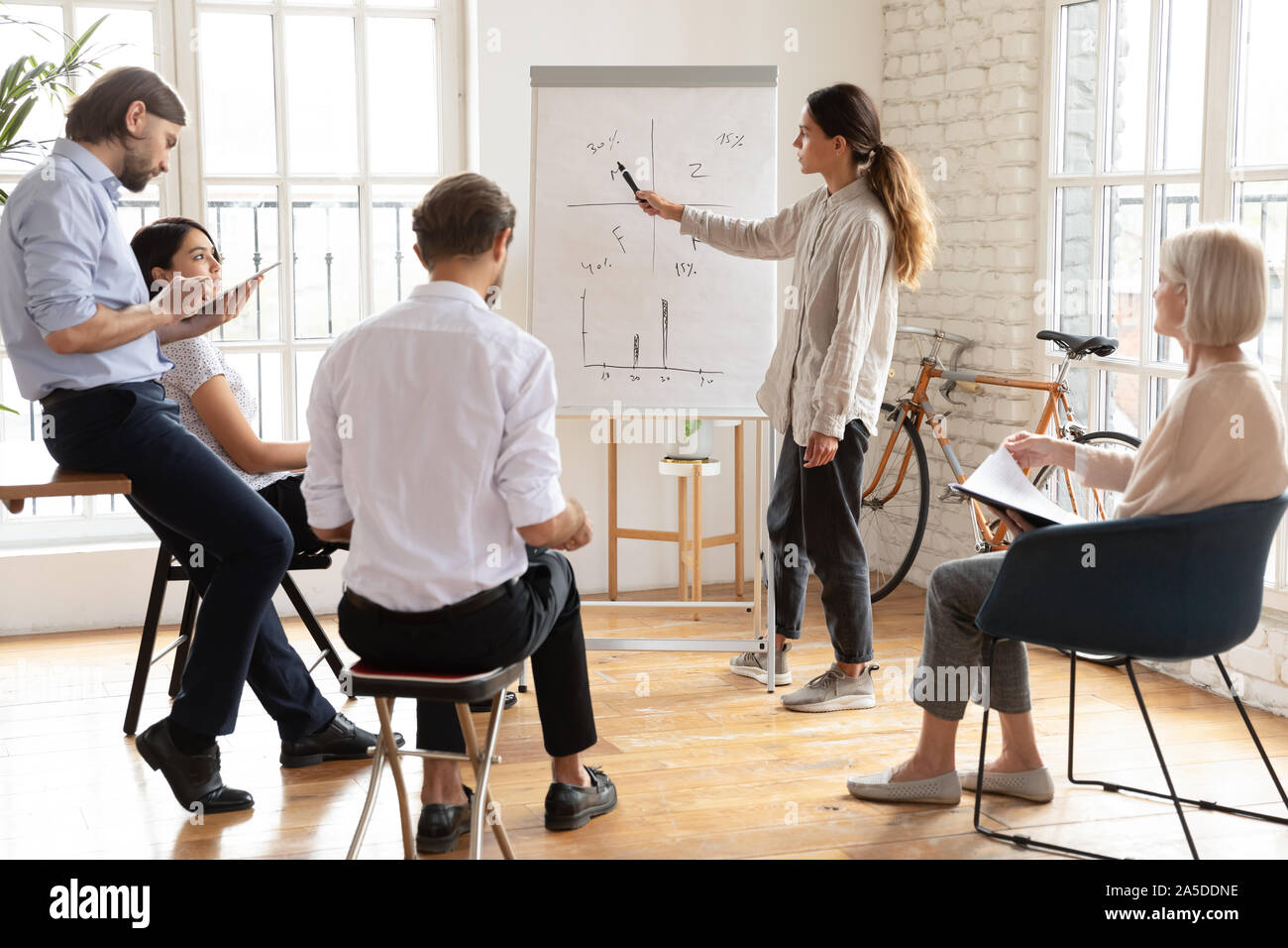 Serious young female manager coach give presentation at corporate ...