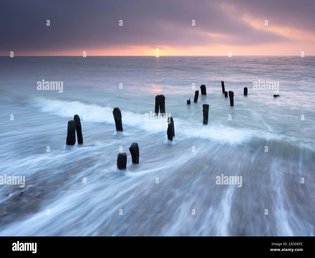 Receding waves on Winchelsea beach. Winchelsea, East Sussex, England, UK Stock Photo