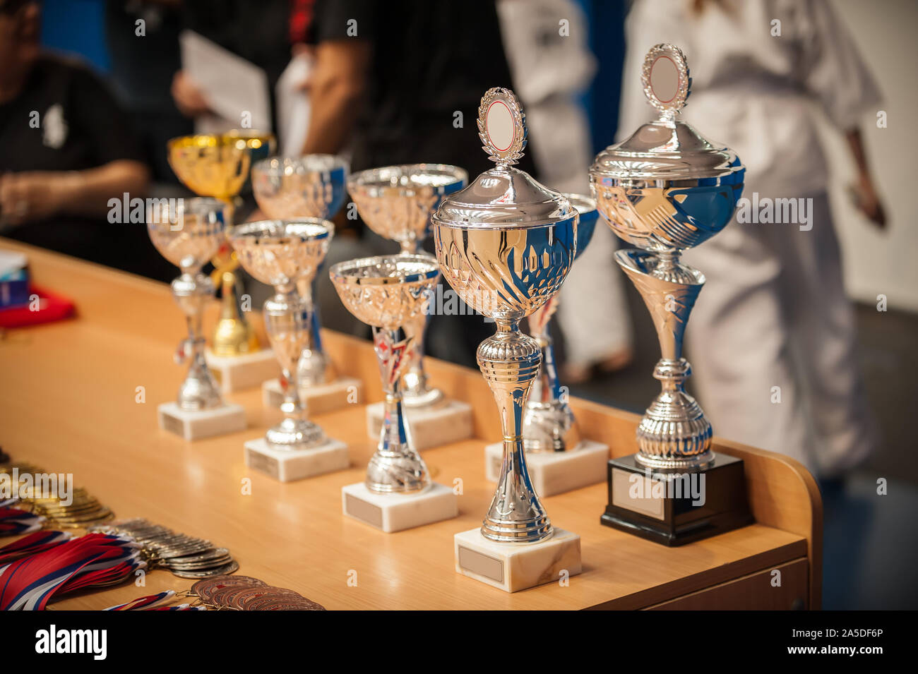 Gold champion winner awards trophies and medals lined up in rows. Selective focus Stock Photo