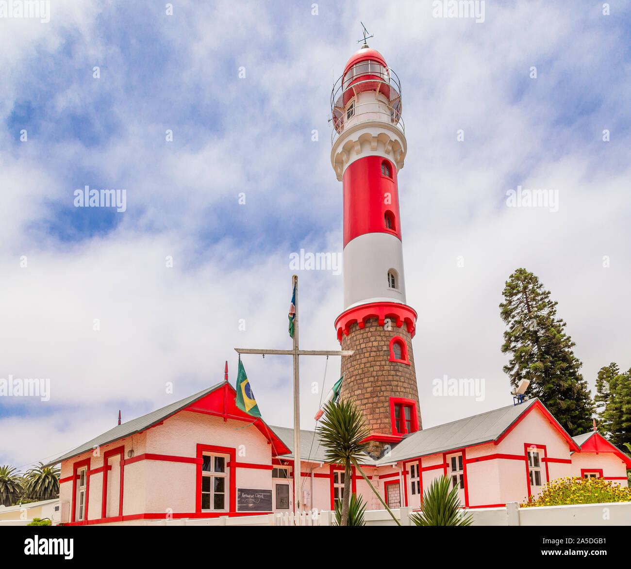 Red white painted beacon, and houses, Swakopmund, German  colonial town, Namibia Stock Photo