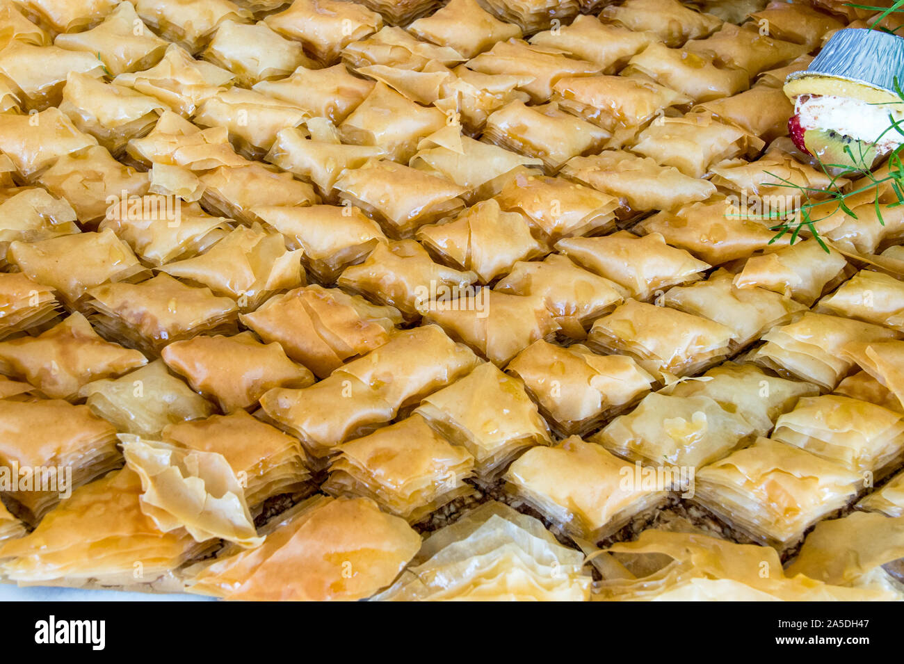 Honey soaked Baklava prepared with phyllo pastry, crunchy pistachio and drizzled with honey. Ready to be served and devoured Stock Photo