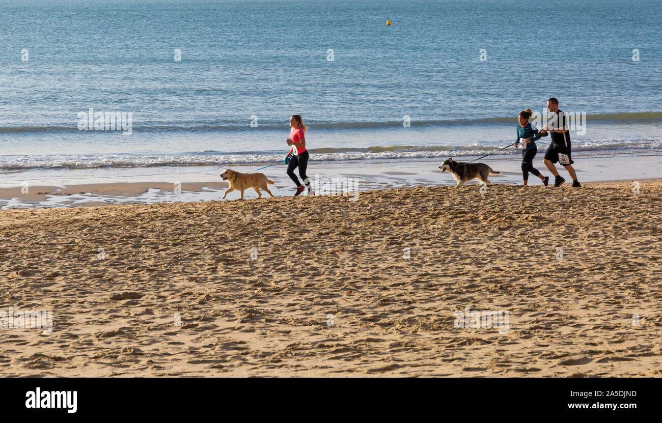 Bournemouth, Dorset, UK. 20th October 2019. Participants take part in the Beach Race, Race the Tide, a low tide beach run along the beautiful shoreline of Bournemouth beach towards Sandbanks beach. Runners run the 5k or 10k race along the seashore and over the groynes before the tide comes in. A dry chilly early morning with some sunshine. Credit: Carolyn Jenkins/Alamy Live News Stock Photo