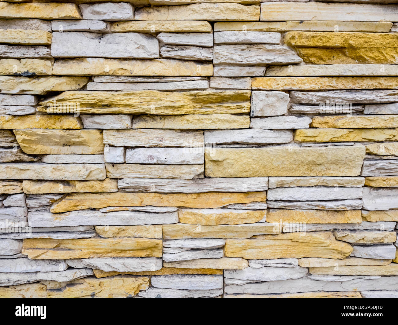 Part of stone masonry with rectangular stones, rough old wall background Stock Photo