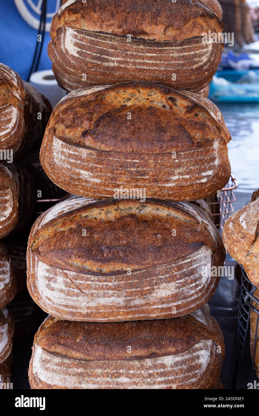 https://c8.alamy.com/comp/2A5DNEY/freshly-baked-rustic-sourdough-bread-on-a-food-market-stall-2A5DNEY.jpg