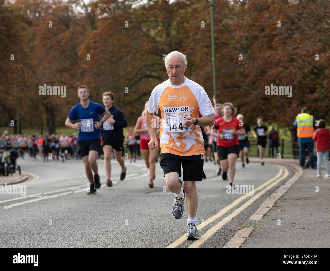 Senior male runner during the Cambridge Town and Gown 10k October 2019 scenic run passing landmarks, historic University Colleges and the river cam Stock Photo