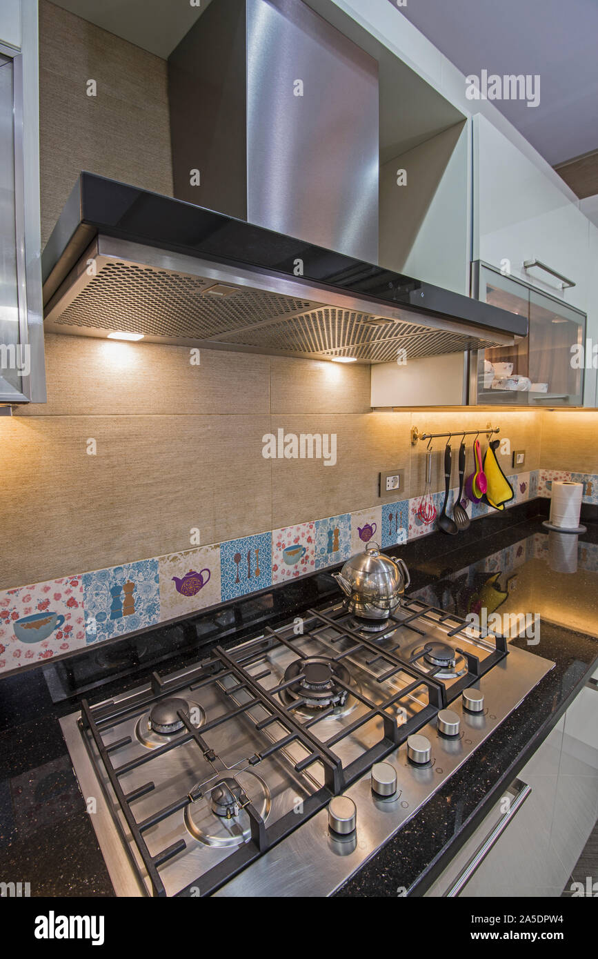 Interior design decor showing modern kitchen cooker hob appliance with extractor fan in luxury