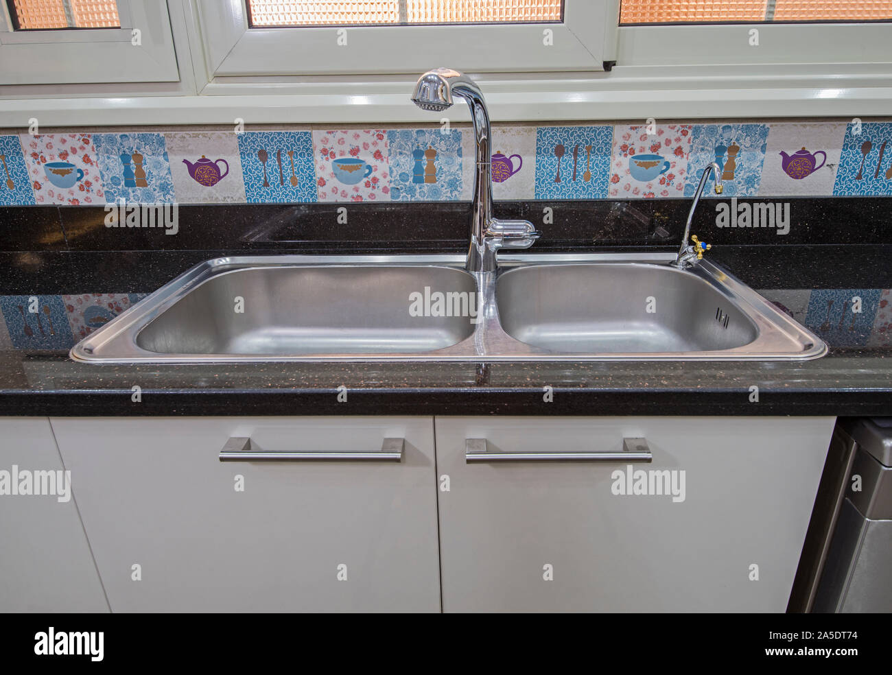 Interior design decor showing modern kitchen with metal sink in luxury