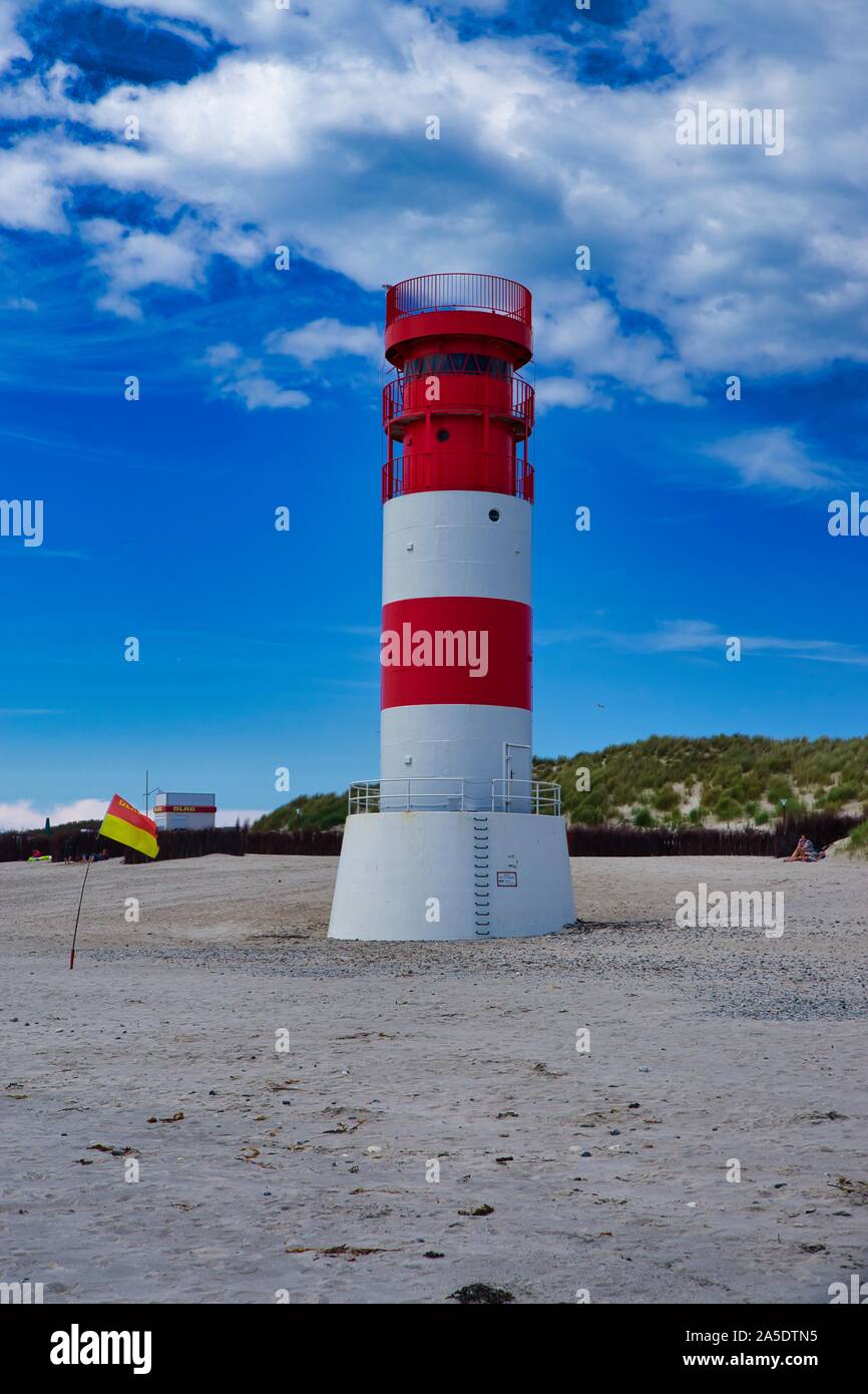 The red and white small Lighthouse on Island Dune - Heligoland - Germany with blue Sky Stock Photo