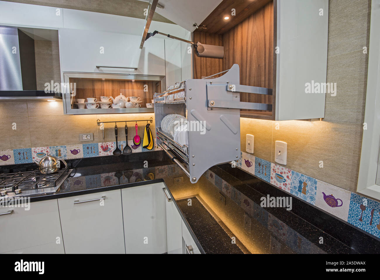 https://c8.alamy.com/comp/2A5DWAX/interior-design-decor-showing-modern-kitchen-with-swinging-cupboard-in-luxury-apartment-showroom-2A5DWAX.jpg