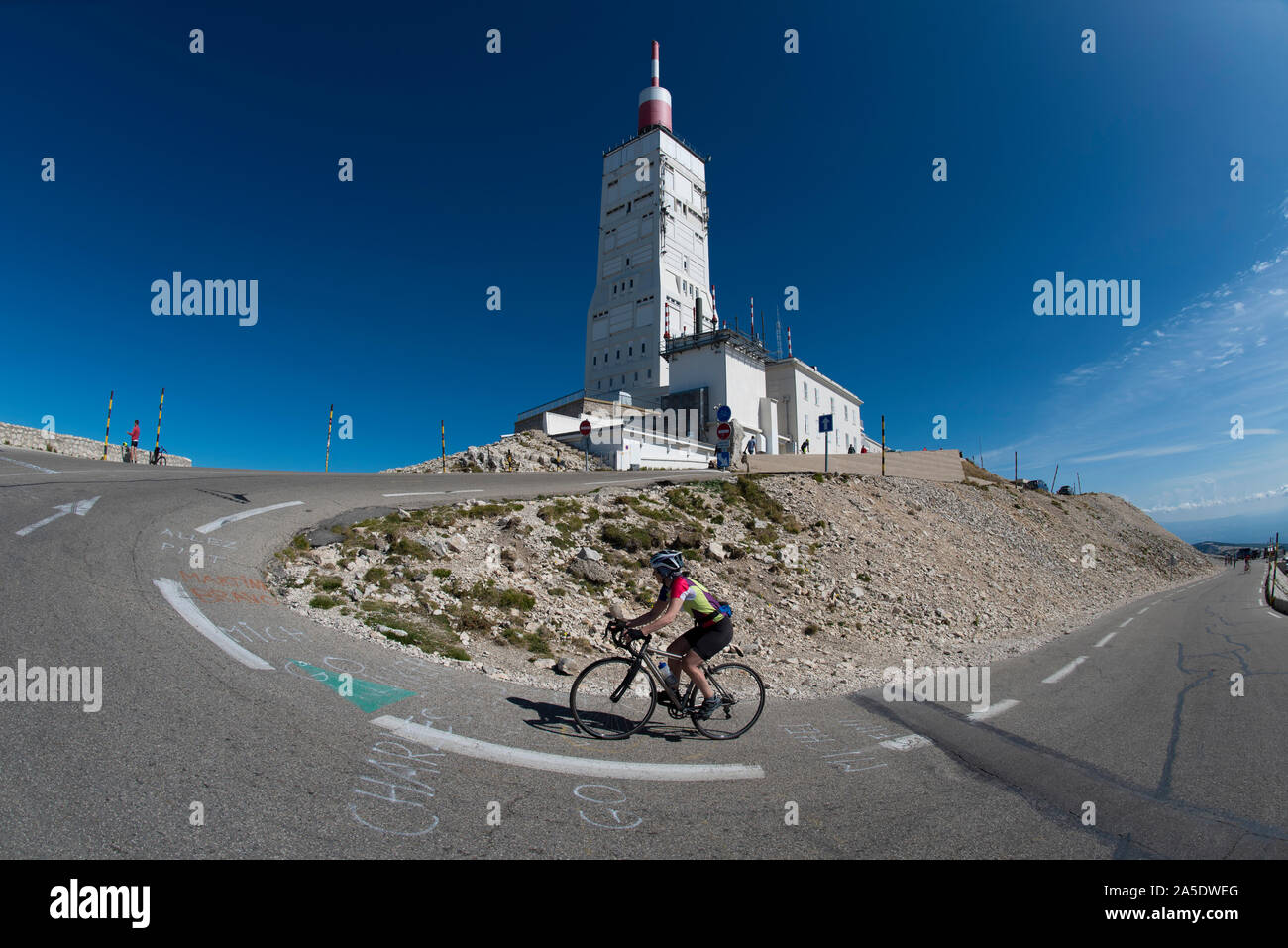 Mature female cyclist on final bend of climb to the summit of Mont