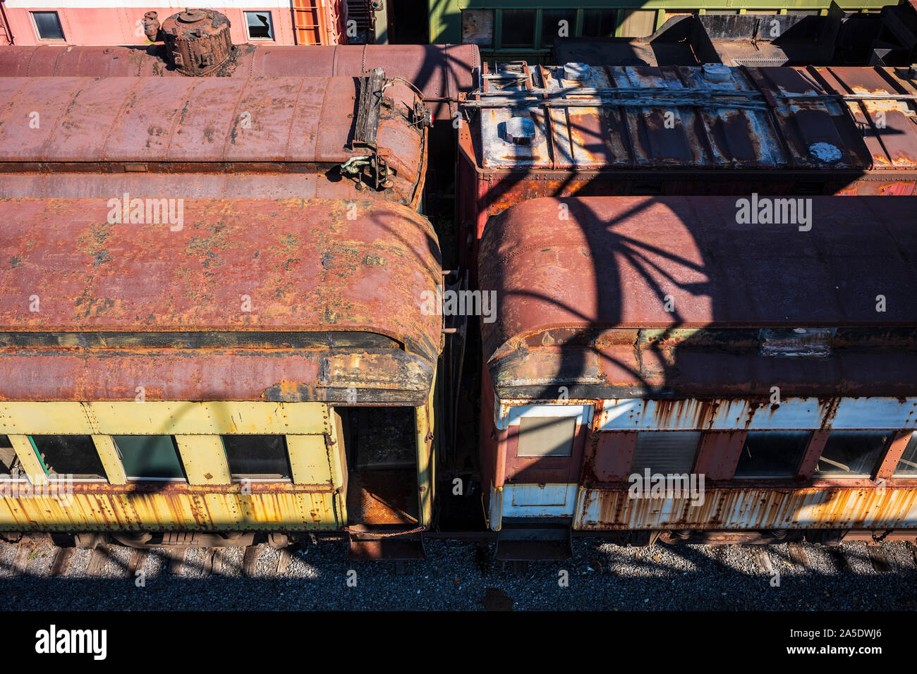 Vintage train cars and locomotives, covered in rust and are in ...