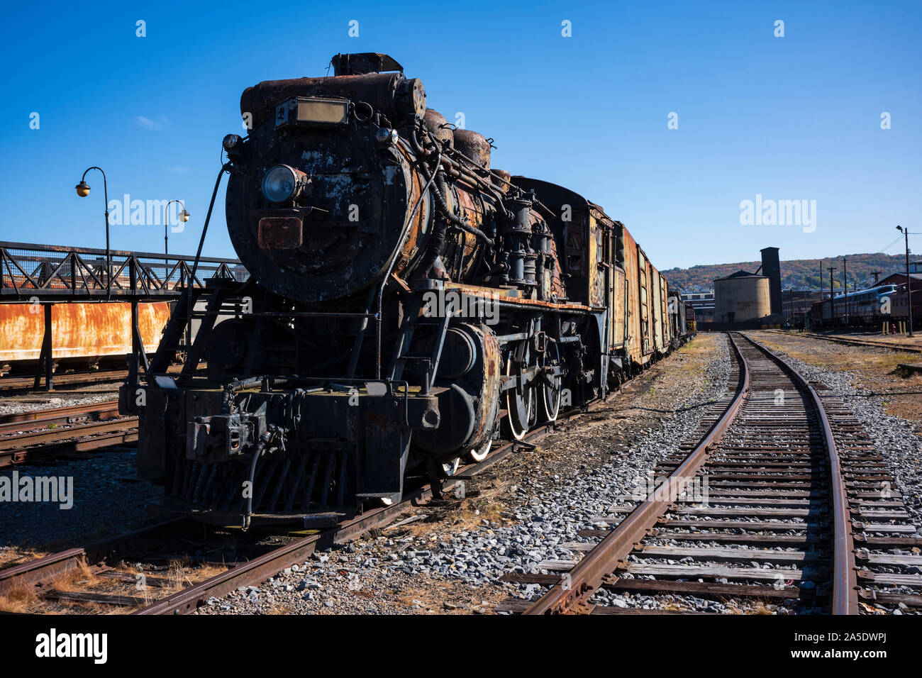 Vintage train cars and covered in rust and are in
