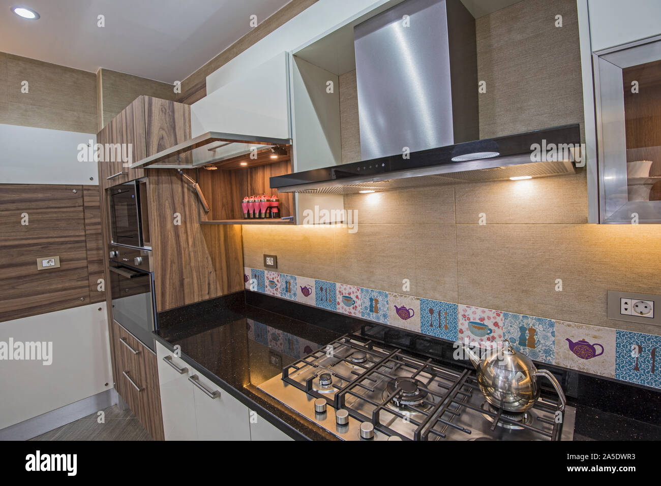 Interior design decor showing modern kitchen cooker hob appliance with extractor fan in luxury