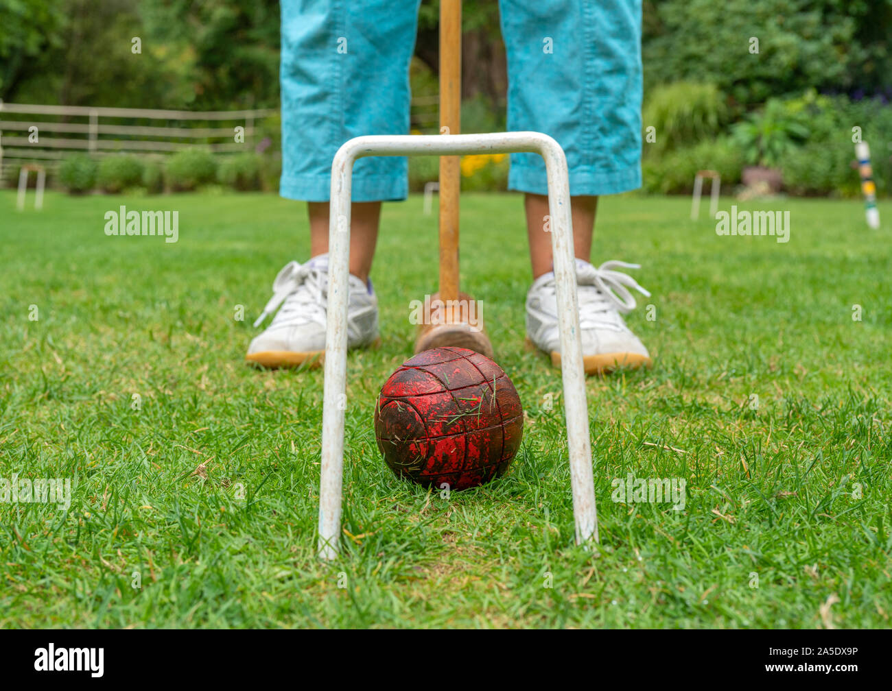 Playing the traditional game of Croquet on a lawn in England, United