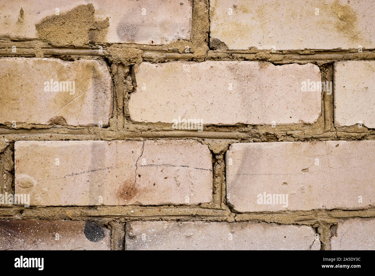 Old brick wall closeup. Abstract background from dilapidated bricks. Stock Photo