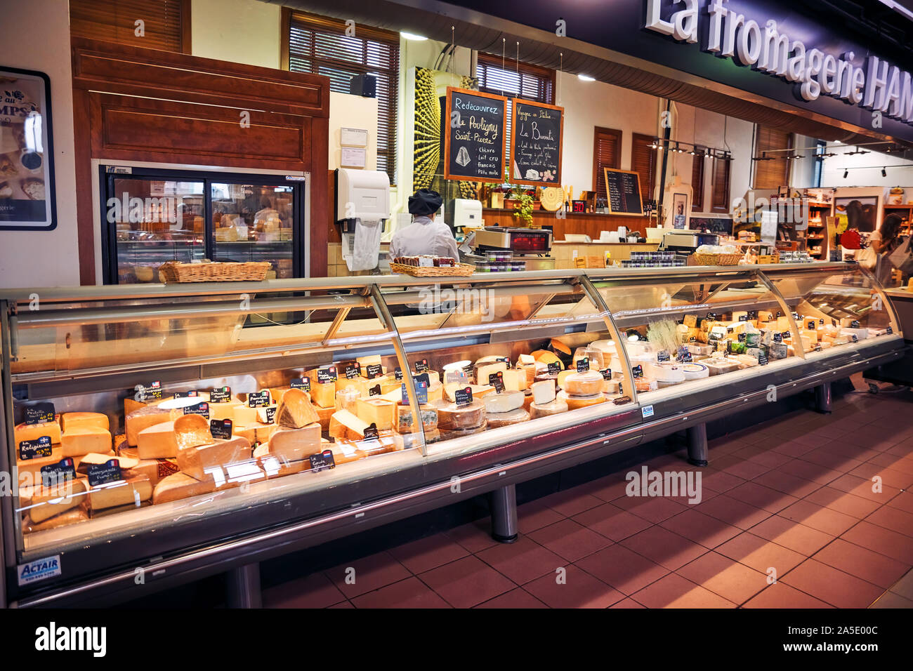 Delicatessen shop with various cheese in the display and a