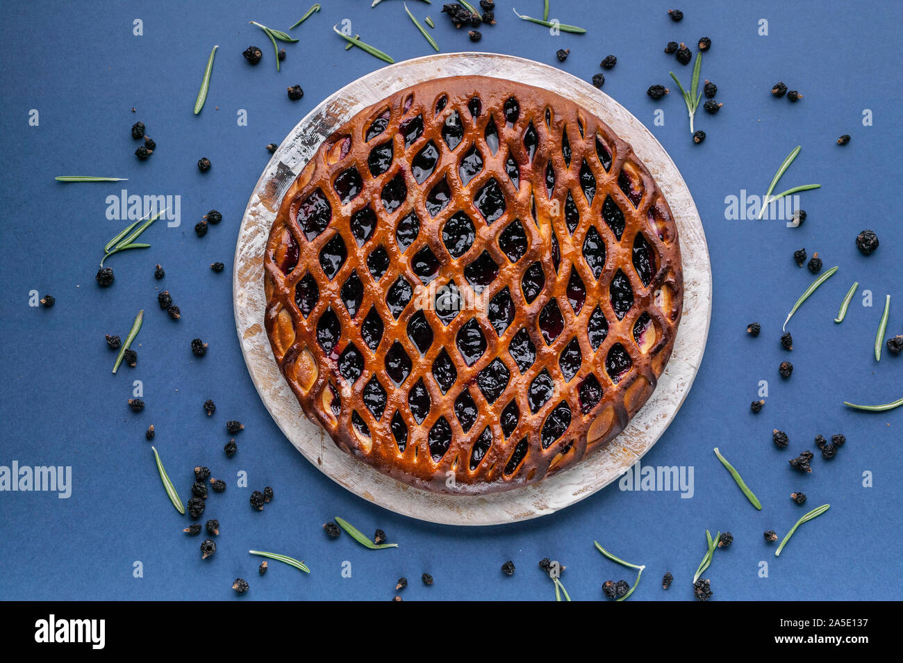 Open Cake File Top view Homemade open cake with black currant on a dark blue ...