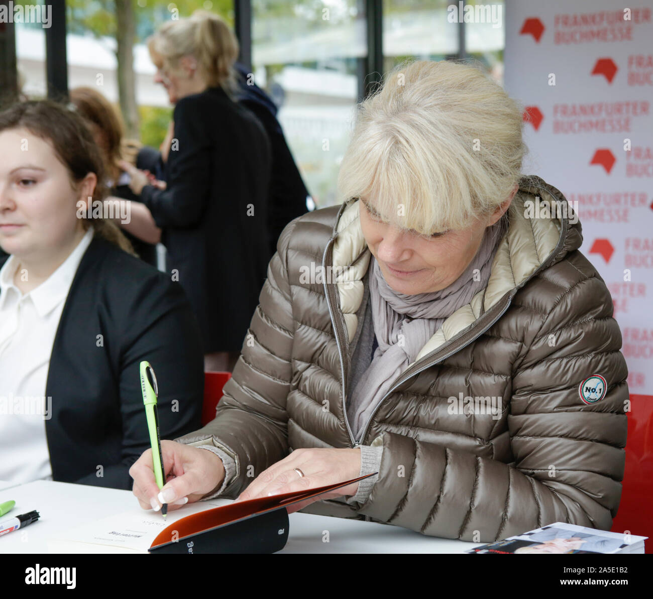 German crime writer Nele Neuhaus signs a book at the Frankfurt Book Fair. The 71th Frankfurt Book Fair 2019 is the world largest book fair with over 7,500 exhibitors and over 285,000 expected visitors. The Guest of Honour for the 2019 fair is Norway. (Photo by Michael Debets/Pacific Press) Stock Photo