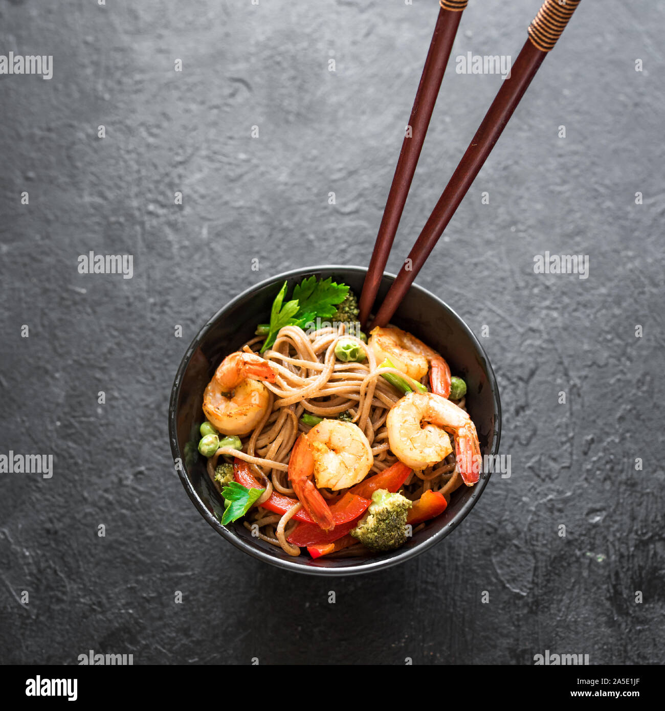 Stir fry with soba noodles, shrimps (prawns) and vegetables. Asian