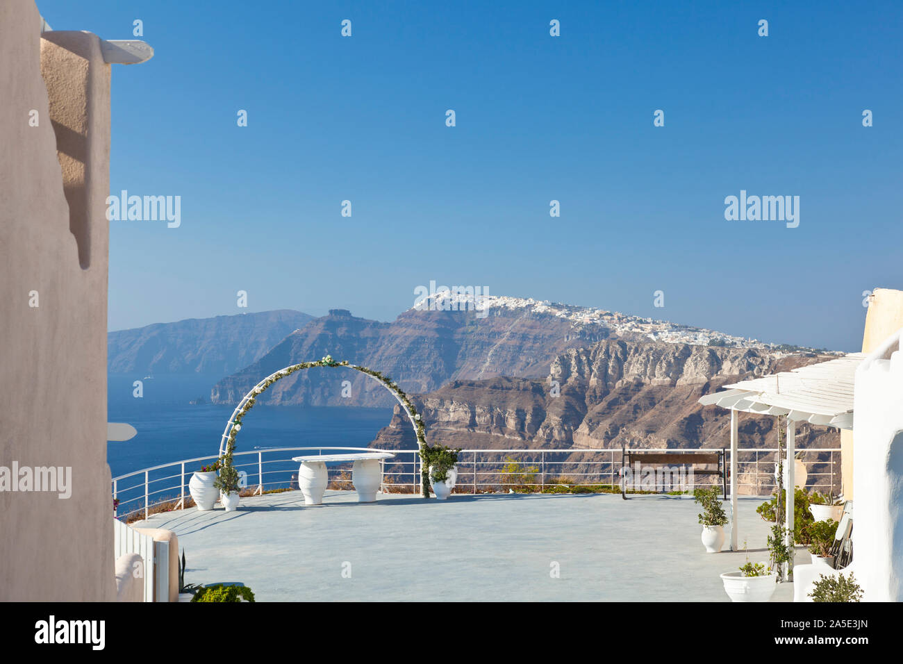 View of a wedding setup in the south of Santorini to the center with the villages on the crater rim. Stock Photo