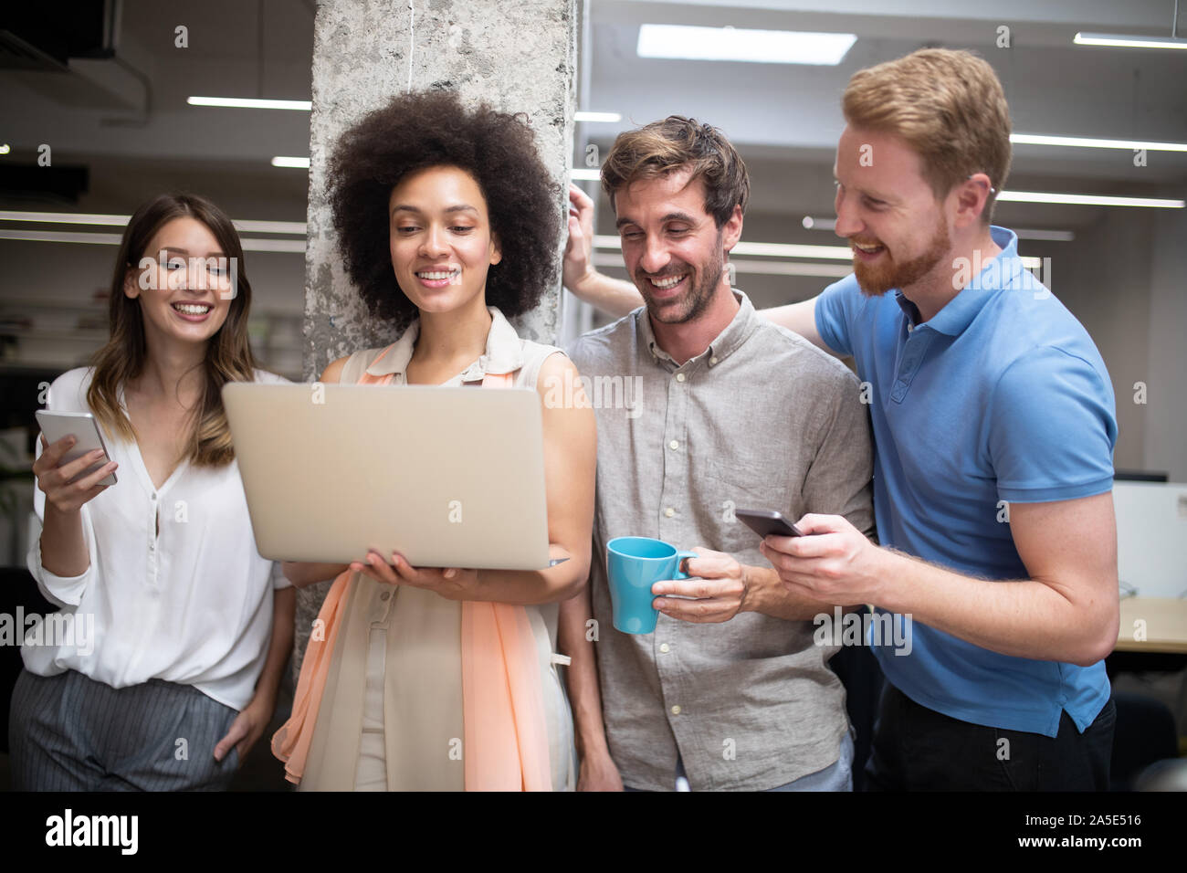 Programmers cooperating at IT company developing apps Stock Photo