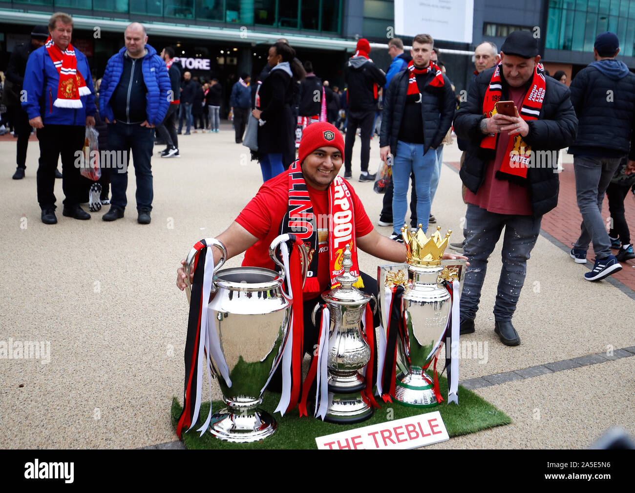 A Manchester United Fan Poses For A Photo With The Treble Trophies Outside The Stadium Before The Premier League Match At Old Trafford Manchester Stock Photo Alamy