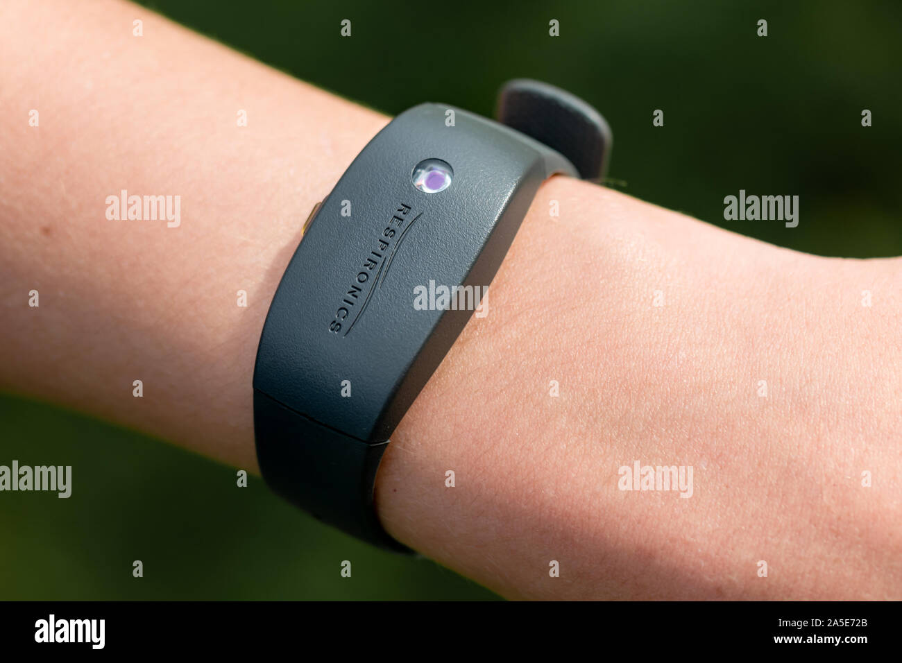 An arm wearing a Philips Respironics Actiwatch, a clinical research-grade tracker watch for insomnia, sleep studies and activity monitoring Stock Photo