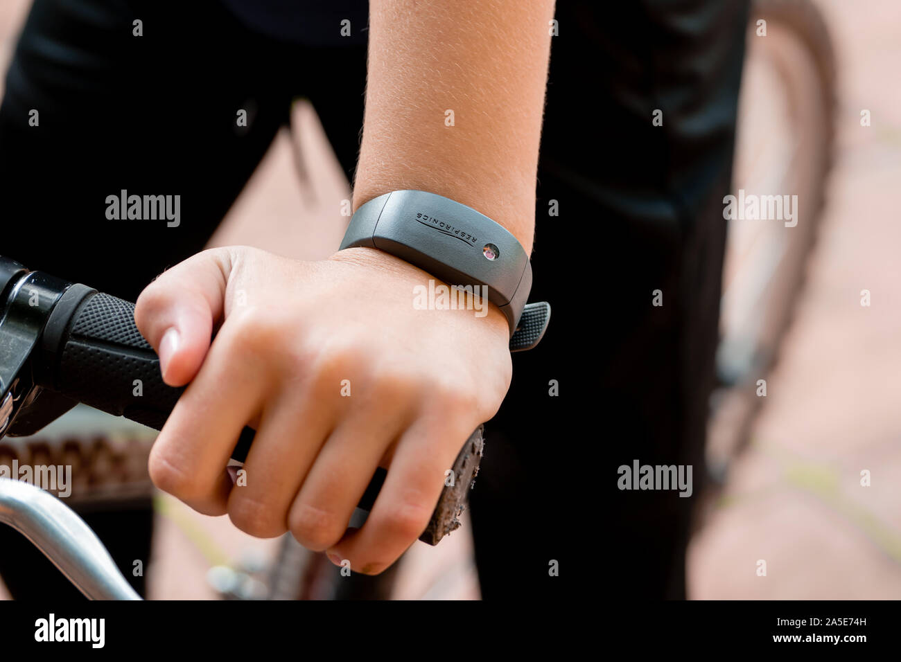 An active teenager on a bike wearing a Philips Respironics Actiwatch, a