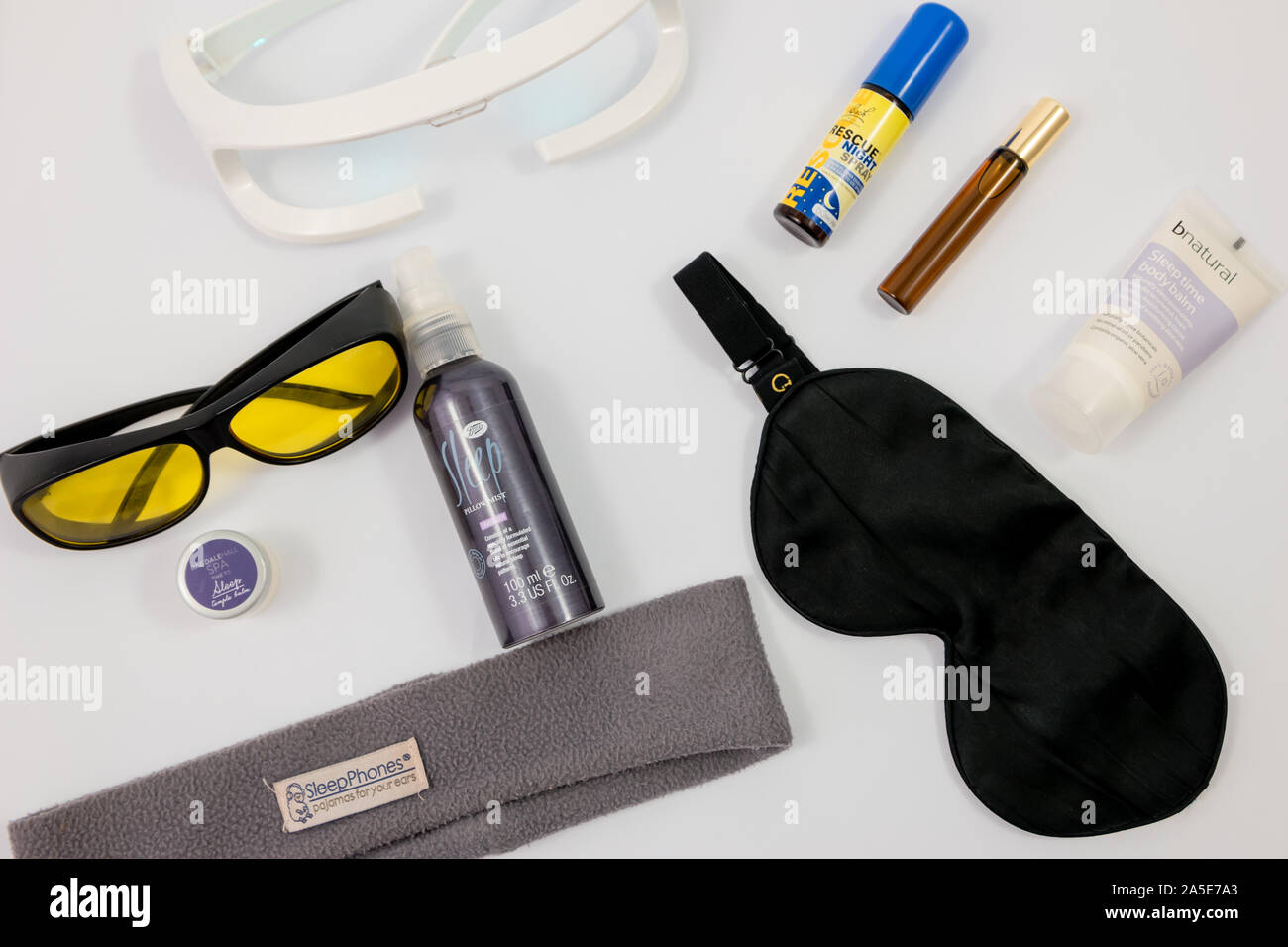 A range of complementary therapy products and gadgets for insomnia and sleep disorders. Aromatherapy, eye mask, sleepphones, yellow glasses Stock Photo