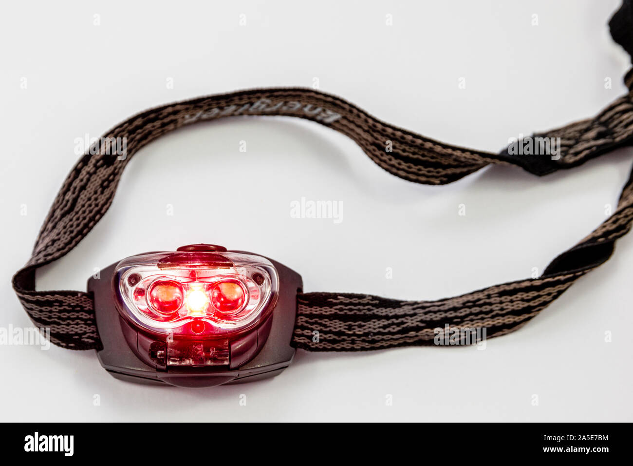 A red light LED miners head torch for night reading, to limit blue light, to help night vision in camping, astronomy Stock Photo