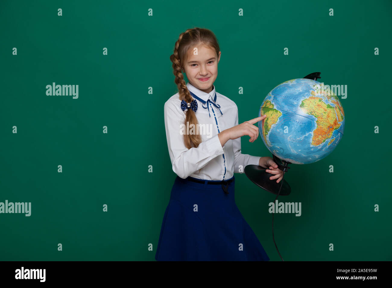 girl with a globe in geography class at the board at school Stock Photo ...