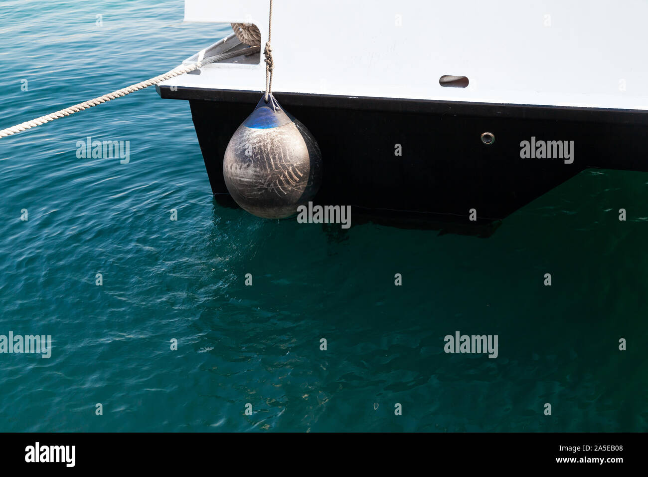 Boat fender ball, round anchor buoy hanging on a yacht stern Stock Photo Alamy