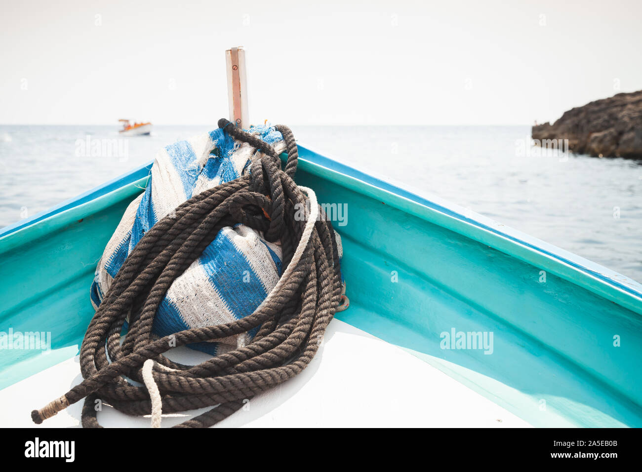 Bow of a small pleasure boat with nautical rope at summer sunny day Stock Photo