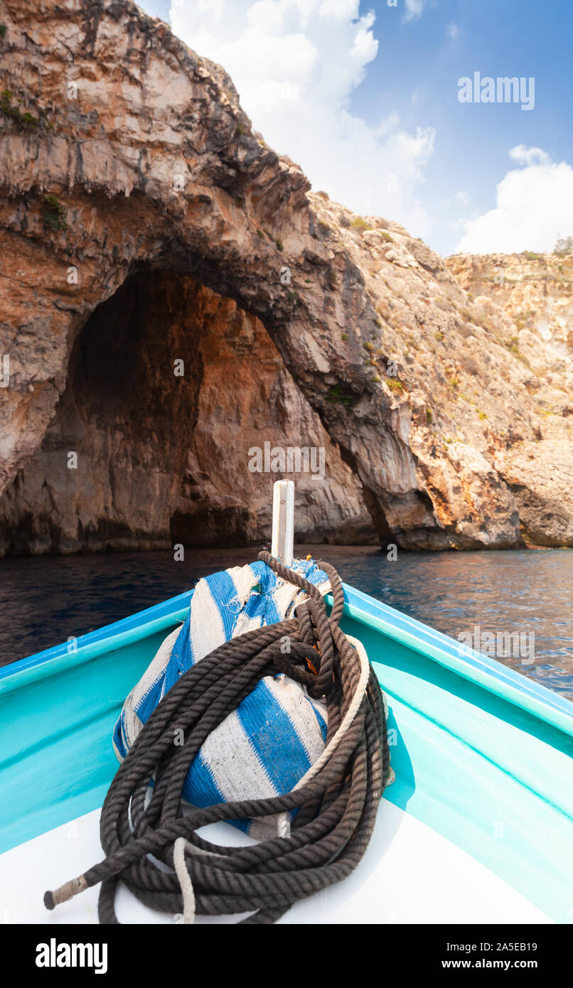 Bow of a small pleasure boat with nautical rope at summer sunny day. Blue cave, Malta Stock Photo