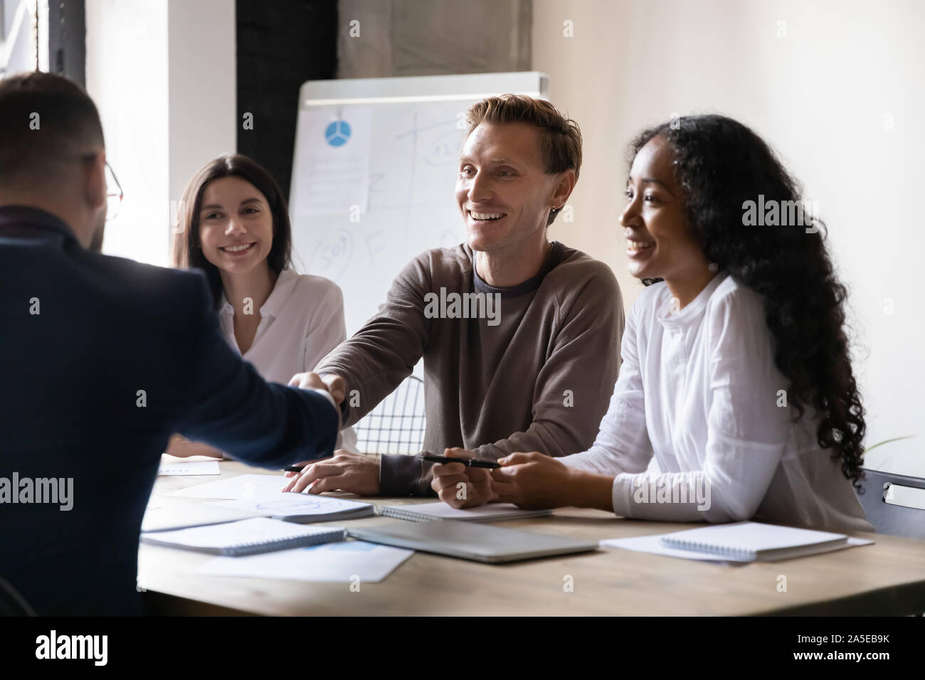 Happy hr employer handshake male applicant partner at interview meeting Stock Photo