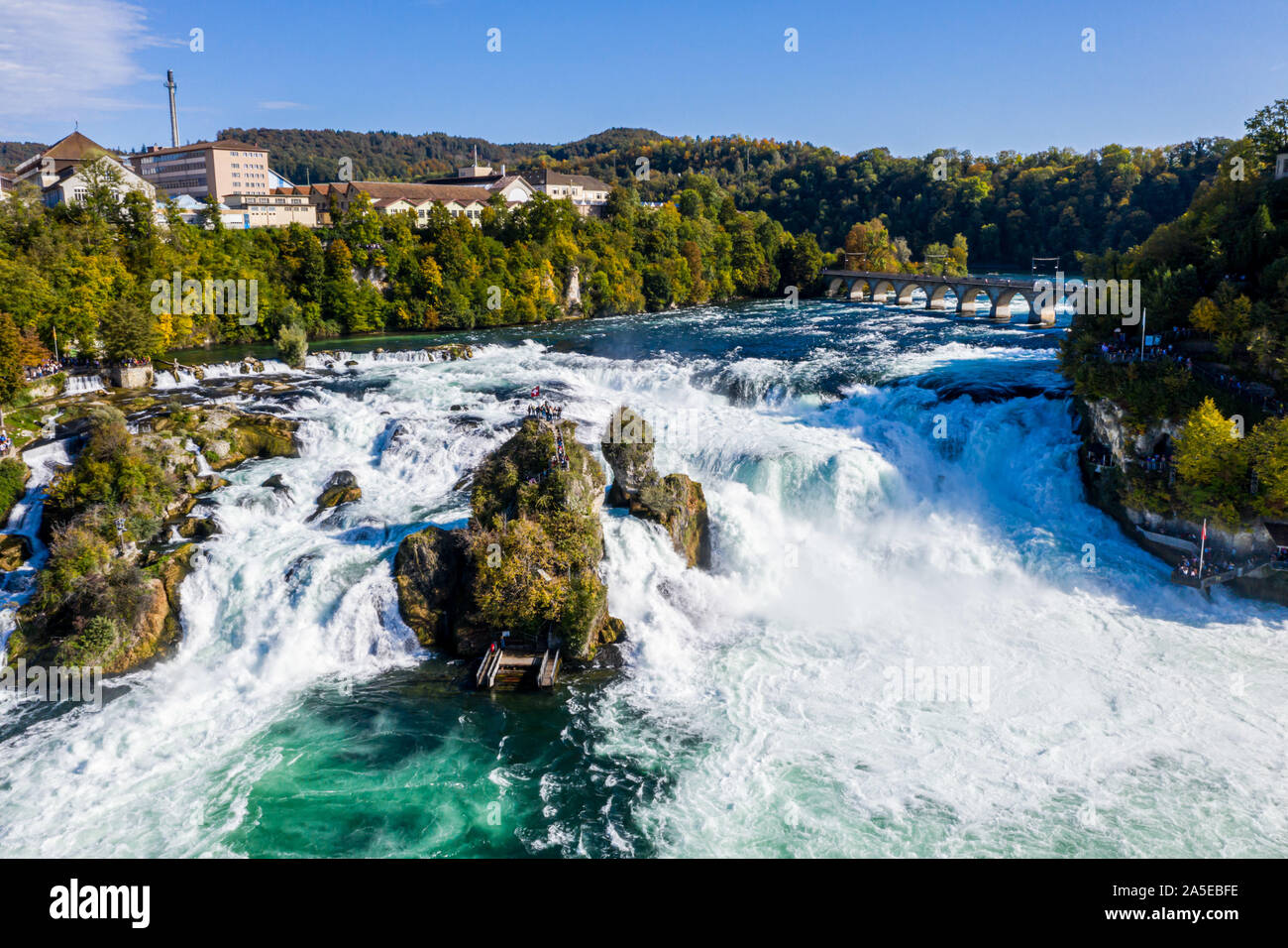 Rhine Falls, Rheinfall, Switzerland panoramic aerial view. Tourist boat in waterfall. Bridge and border between the cantons Schaffhausen and Zurich. C Stock Photo