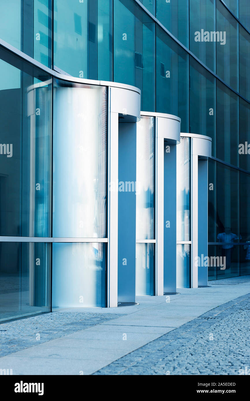 New revolving door of office building, corporate, blue toned image Stock Photo