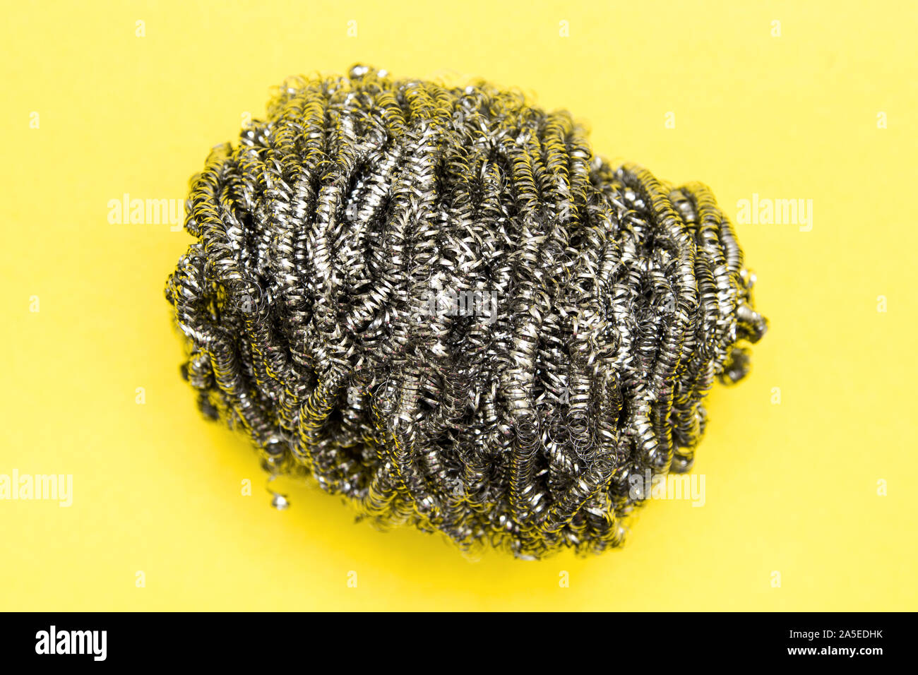 Metal sponge for washing dishes closeup on a colored background with copy space Stock Photo Alamy