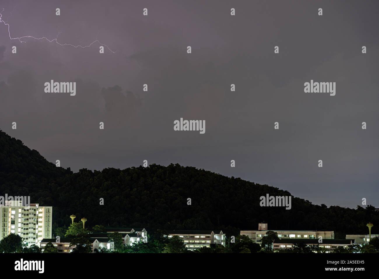 The Storm lightning strikes in mountains during a thunderstorm at night. Beautiful dramatic view Stock Photo
