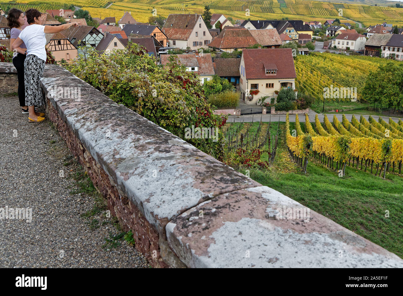 HUNAWIHR, FRANCE, October 13, 2019 : Women admire the vineyard landscape around the village from the fortification of the old church. Stock Photo