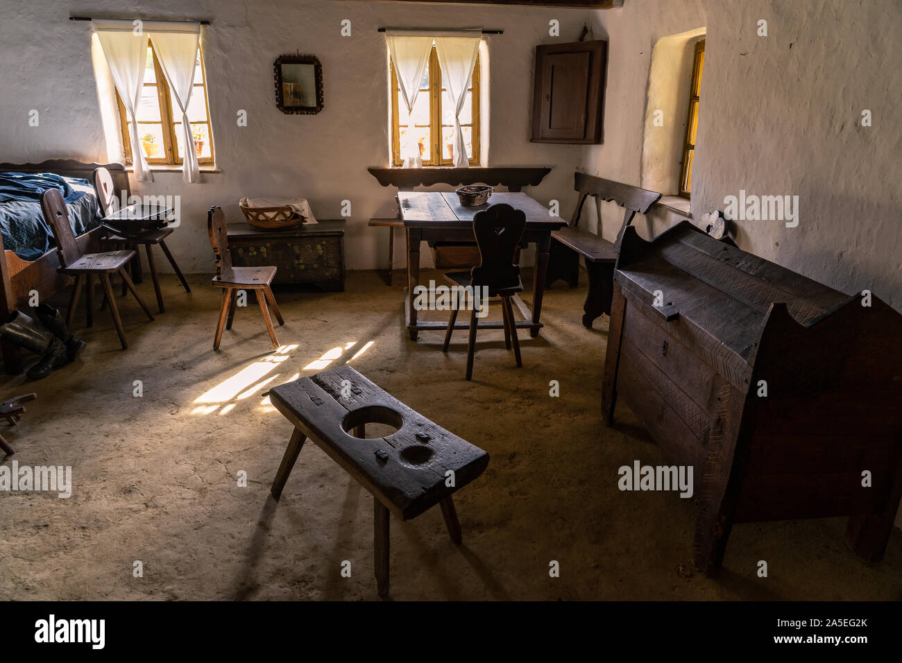 old hungarian village museum tiller house with light from the window Stock Photo