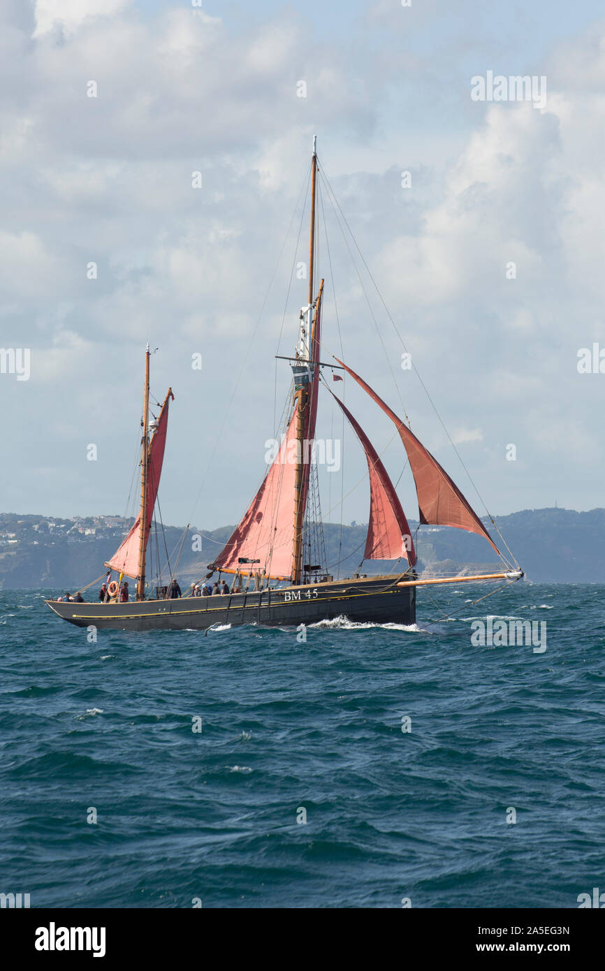 The Pilgrim BM45, a restored, wooden sailing trawler built originally in 1895. The Pilgrim is seen here in Tor Bay not far from the fishing town of Br Stock Photo