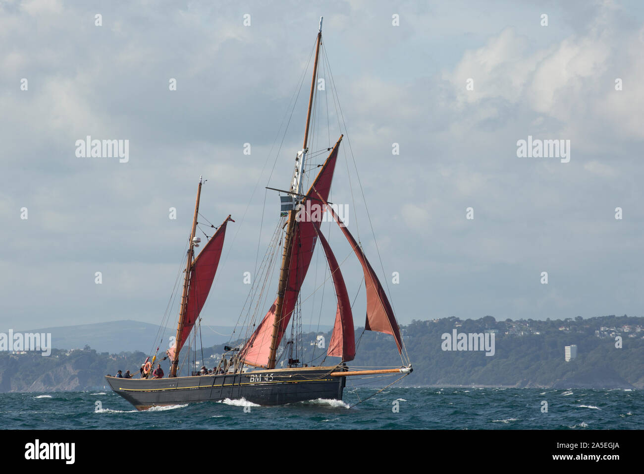 The Pilgrim BM45, a restored, wooden sailing trawler built originally in 1895. The Pilgrim is seen here in Tor Bay not far from the fishing town of Br Stock Photo