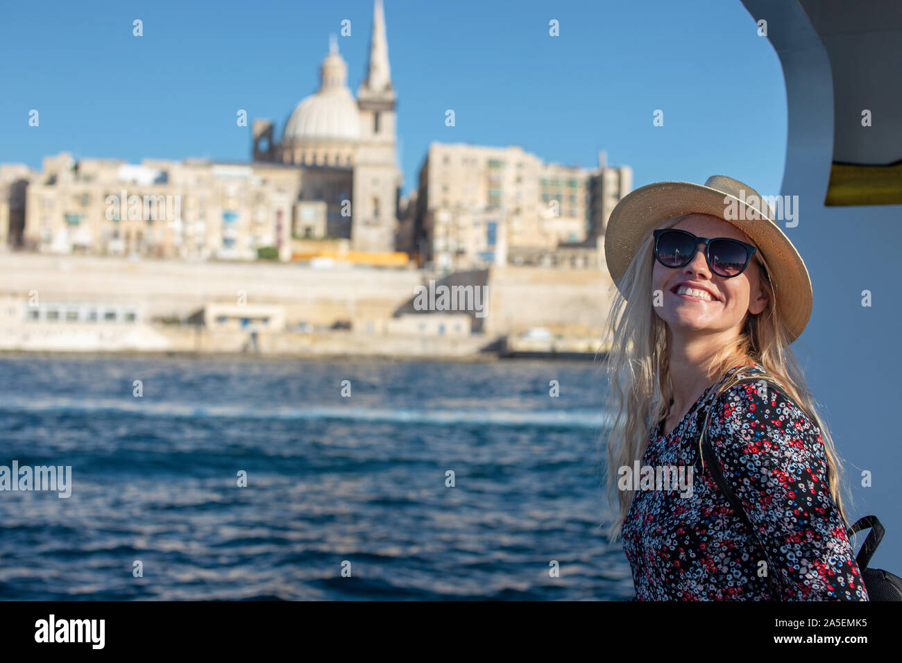Happy young 20s traveler woman arriving to Valletta, Malta Stock Photo