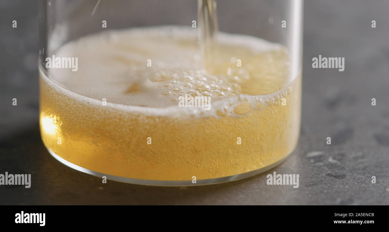 Closeup Pour Pear Cider Into Glass On Terrazzo Countertop Wide