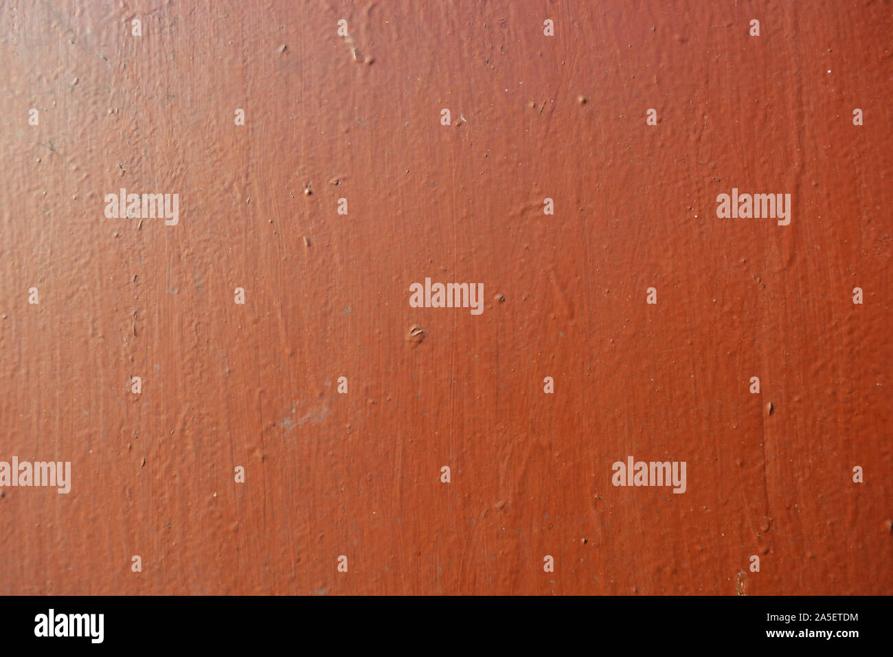 Old metal building sheet covered with brown paint with a golden tint in