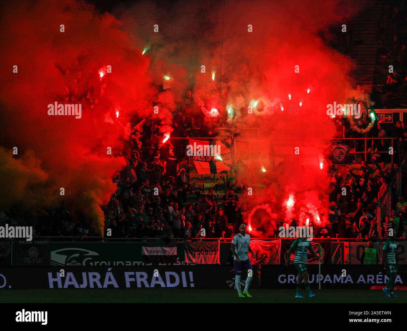 BUDAPEST, HUNGARY - OCTOBER 19: Ultras of Ferencvarosi TC light torches during the Hungarian OTP Bank Liga match between Ferencvarosi TC and Ujpest FC at Groupama Arena on October 19, 2019 in Budapest, Hungary. Stock Photo