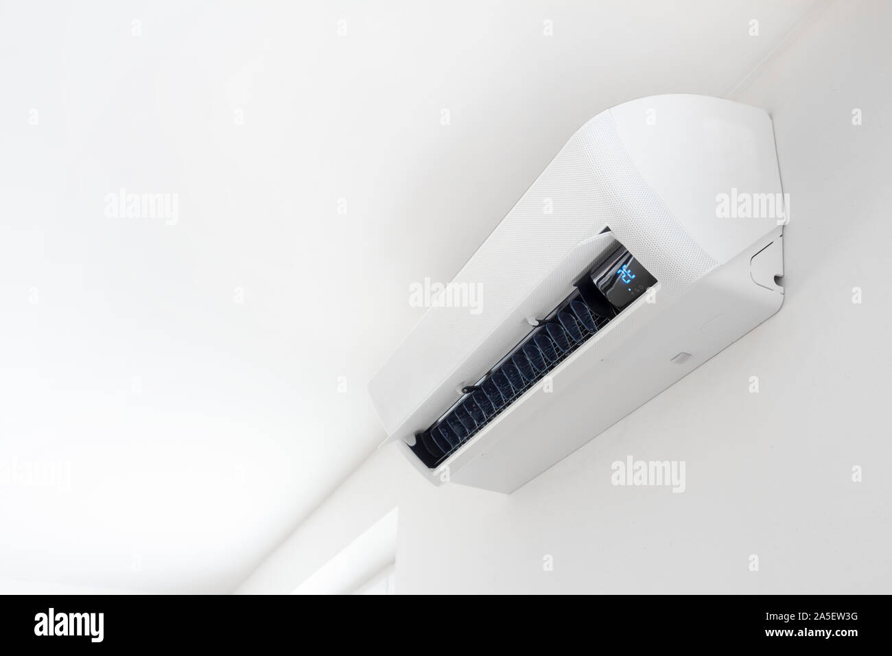 Air conditioner on white wall in interior Stock Photo